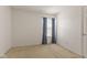 This bedroom features neutral carpeting and a window with blue curtains at 11105 Deer Valley Dr, Indianapolis, IN 46229