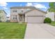 Charming two-story home with attached two car garage, manicured lawn, and inviting front porch at 11105 Deer Valley Dr, Indianapolis, IN 46229