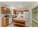 A well-lit kitchen featuring an island, tile floor, and plenty of cabinets at 11105 Deer Valley Dr, Indianapolis, IN 46229