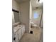 Clean bathroom with a tiled backsplash, single sink vanity, and a window at 114 S Green St, Brownsburg, IN 46112