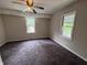 A spacious bedroom with neutral walls, carpeting, ceiling fan, and natural light from two windows at 114 S Green St, Brownsburg, IN 46112