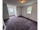 Bedroom featuring carpeted floors, two windows providing natural light, and a convenient closet space at 114 S Green St, Brownsburg, IN 46112