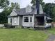 Charming single-Gathering home with gray siding, a chimney, and a well-manicured lawn at 114 S Green St, Brownsburg, IN 46112