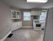 Well-lit kitchen featuring white appliances and ample cabinet space at 114 S Green St, Brownsburg, IN 46112