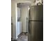 Kitchen area with modern stainless steel refrigerator and convenient washer and dryer at 114 S Green St, Brownsburg, IN 46112