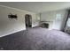Inviting living room with plush carpeting and a cozy fireplace at 114 S Green St, Brownsburg, IN 46112