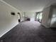 Open living room featuring plush carpeting and a decorative fireplace at 114 S Green St, Brownsburg, IN 46112