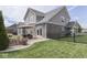 Large two-story home's fenced backyard, patio set, and lush lawn at 1215 W Curry Rd, Greenwood, IN 46143
