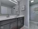 Bathroom with double vanity, framed mirror, and stylish tile flooring at 1215 W Curry Rd, Greenwood, IN 46143