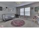 Charming bedroom decorated with modern floral decor, a rocking chair, and ample light at 1215 W Curry Rd, Greenwood, IN 46143