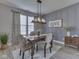 Tastefully decorated dining area with a wooden table, pendant lighting, and decorative curtains at 1215 W Curry Rd, Greenwood, IN 46143