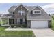 Charming two-story brick home with a well-manicured lawn, attached two-car garage, and inviting curb appeal at 1215 W Curry Rd, Greenwood, IN 46143