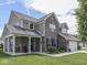 Beautiful exterior view of a brick home showcasing a welcoming front porch and well-maintained landscaping at 1215 W Curry Rd, Greenwood, IN 46143