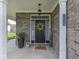 Inviting front porch with decorative plants, wreath, and a 'welcome' sign at 1215 W Curry Rd, Greenwood, IN 46143