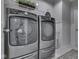Laundry room featuring gray front loading washer and dryer and a wire rack above at 1215 W Curry Rd, Greenwood, IN 46143