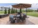 A beautiful outdoor patio with a table, chairs, umbrella, and a barbecue grill, perfect for outdoor entertaining at 1215 W Curry Rd, Greenwood, IN 46143
