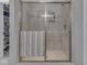 Bathroom shower with clear sliding glass door and a white tile surround at 1215 W Curry Rd, Greenwood, IN 46143