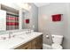 Modern bathroom featuring a double sink vanity, a large mirror, and a shower with a stylish curtain at 12343 Slate Dr, Fishers, IN 46037