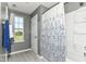 Bright bathroom showcasing a patterned shower curtain and a window view, creating a refreshing and functional space at 12343 Slate Dr, Fishers, IN 46037