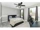 Inviting bedroom with plush carpet, modern ceiling fan, and large windows offering natural light at 12343 Slate Dr, Fishers, IN 46037