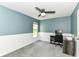 Comfortable bedroom with a ceiling fan, a large window, gray carpet and wainscotting and a computer desk at 12343 Slate Dr, Fishers, IN 46037