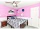 Charming bedroom featuring soft carpet, wainscotting, unique wall decor and calming pink walls at 12343 Slate Dr, Fishers, IN 46037