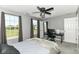 Bright bedroom with plush carpet, contemporary ceiling fan, large windows, and neutral walls at 12343 Slate Dr, Fishers, IN 46037
