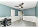 Inviting bedroom featuring a ceiling fan, gray carpet, wainscotting and an open door at 12343 Slate Dr, Fishers, IN 46037