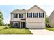 Charming two-story home with a well-manicured lawn and a two-car attached garage at 12343 Slate Dr, Fishers, IN 46037