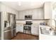 Well-lit kitchen boasts gray cabinets, stainless steel appliances, and a window view, perfect for cooking enthusiasts at 12343 Slate Dr, Fishers, IN 46037