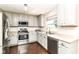 Well-lit kitchen boasts gray cabinets, stainless steel appliances, and a window view, perfect for cooking enthusiasts at 12343 Slate Dr, Fishers, IN 46037