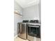 Well-equipped laundry room with modern, front-loading washer and dryer, plus handy shelving for storage at 12343 Slate Dr, Fishers, IN 46037