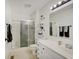Bathroom with a shower, white cabinets, and decorative shelves at 12515 Traverse Pl, Fishers, IN 46038