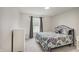 Comfortable bedroom with neutral carpet, a cozy bed, natural light, and ample space for storage at 12515 Traverse Pl, Fishers, IN 46038