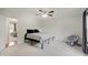 Cozy bedroom with a ceiling fan, sitting chair, and ample natural light at 12515 Traverse Pl, Fishers, IN 46038