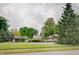 A residential community offers amenities such as a pool, parking, and sports court amidst lush greenery and cloudy sky at 12515 Traverse Pl, Fishers, IN 46038