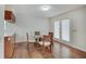 Cozy dining area with laminate floors, glass table and chairs, and natural light from French doors at 12515 Traverse Pl, Fishers, IN 46038