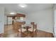 Cozy dining area with wood floors and a glass table, adjacent to the kitchen for easy serving at 12515 Traverse Pl, Fishers, IN 46038