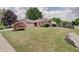 Well-maintained front yard with lush green grass and mature trees enhancing curb appeal at 12515 Traverse Pl, Fishers, IN 46038