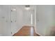Bright hallway with wood floors leading to a welcoming front door and ample closet space at 12515 Traverse Pl, Fishers, IN 46038