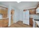 Functional kitchen showcases wood cabinetry, white appliances, laminate floors, and pantry for storage at 12515 Traverse Pl, Fishers, IN 46038
