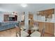 Open living space with wood floors, a round glass dining table, and access to kitchen area with white appliances at 12515 Traverse Pl, Fishers, IN 46038