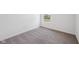 A bright bedroom with a neutral carpet, a double hung window overlooking a large yard, and white trim at 1304 Vera Blvd, Danville, IN 46122