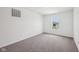 A carpeted bedroom featuring a window with a view of a house at 1304 Vera Blvd, Danville, IN 46122