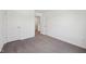 A bright bedroom with carpeted floors, white walls, and two doors at 1304 Vera Blvd, Danville, IN 46122