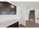 Inviting entryway with dark cabinetry, light countertops, and open staircase to the upper level at 1304 Vera Blvd, Danville, IN 46122