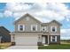 Charming two-story home with white trim windows, a two-car garage, and manicured lawn at 1304 Vera Blvd, Danville, IN 46122