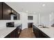 Modern kitchen with black appliances, dark cabinets, white countertops and laminate floor at 1304 Vera Blvd, Danville, IN 46122