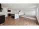 Open-concept kitchen with dark wood cabinets and laminate flooring adjacent to living room at 1304 Vera Blvd, Danville, IN 46122