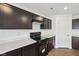 Well-lit kitchen featuring dark wood cabinets, laminate floors, and stainless steel appliances at 1304 Vera Blvd, Danville, IN 46122